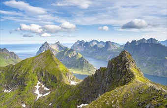 Mountain landscape with steep rocky peaks fjords and sea, view from the top of Munken to