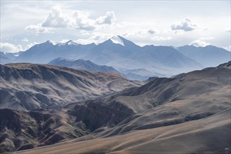 View over eroded mountainous landscape with brown hills, mountains and steppe, Chuy province,