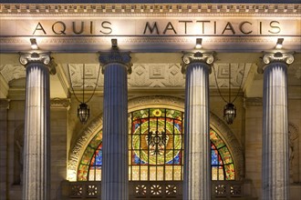 Detail portico with glass window, illuminated spa hotel and Casino in the evening, Wiesbaden,