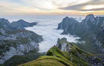 View over Säntis mountains into the valley of Meglisalp at sunrise, Rotsteinpass, high fog in the