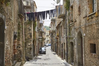 Narrow street in old town, empty, clothesline with laundry over the street, Randazzo, town, Nebrodi