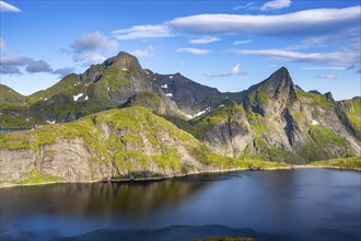 Mountain landscape with lake Tennesvatnet, at sunrise, in the back peak of Hermannsdalstinden,