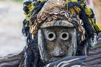 Dancer with traditional wooden mask to drive away evil spirits