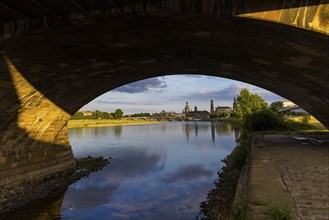 View through the arches of the Marienbrücke onto the Elbe meadows in Dresden's Old Town with