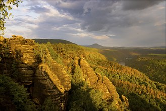 Schrammstein view in the Elbe Sandstone Mountains Looking up the Elbe. Leisurely hikers clamber