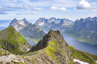 Mountain landscape with steep rocky peaks fjords and sea, view from the top of Munken to