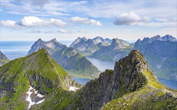 Mountain landscape with steep rocky peaks fjords and sea, view from the top of Munken to