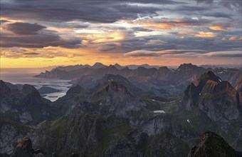 View over mountain top and sea, dramatic sunset, from the top of Hermannsdalstinden, Moskenesöy,