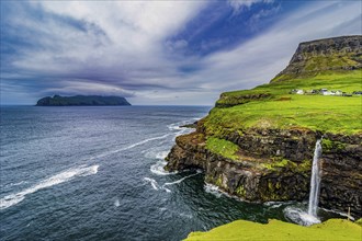 Gasadalur waterfall into the ocean, Vagar, Faroe islands, Denmark, Europe