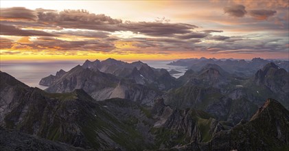 View over mountain top and sea, dramatic sunset, from the top of Hermannsdalstinden, Moskenesöy,