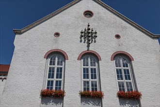 A building with a white façade and flower boxes under a blue sky, Xanten, Lower Rhine, North