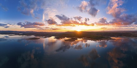 Drone aerial panorama of a lake reservoir of a dam with perfect reflection on the water of the