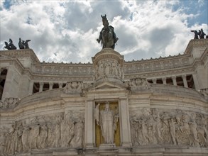 View of a monument decorated with sculptures in Rome under a cloudy sky, rome, italy