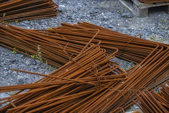 Piles of rusty rebar ready to be used at a construction site