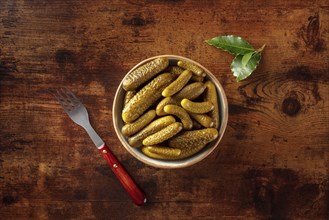 Pickled cucumbers with bay leaf. Fermented food. Homemade canned gherkins. Top shot on a rustic