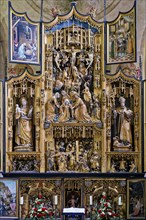 Central carved winged altar with predella, above Crucifixion of Jesus, below Carrying of the Cross,