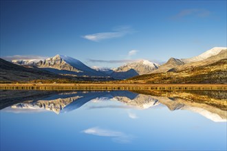 Reflection of the autumn landscape in Rondane National Park, mountains, Doraldalen, Norway, Europe