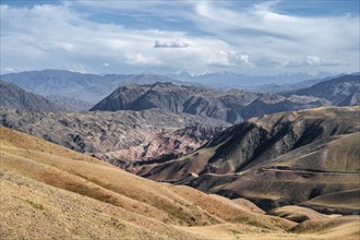 View over eroded mountainous landscape with brown hills, mountains and steppe, Chuy province,