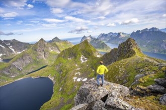 Mountaineers at the summit of Munken, mountain landscape with steep rocky mountain peaks, lake