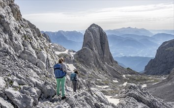 High alpine landscape, snowfields and rock, Two hikers descending from the Hochkönig, Tyrol,