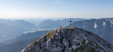 Two hikers at the summit, aerial view, evening mood in the mountains, summit cross of the