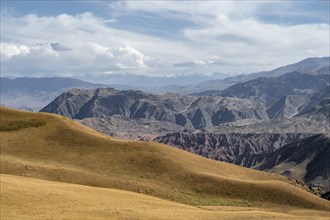 View over eroded mountainous landscape with brown hills, mountains and steppe, Chuy province,