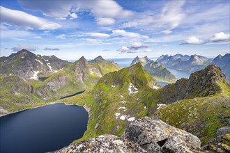 Mountain landscape with steep rocky peaks, lake Tennesvatnet fjords and sea, view from the top of