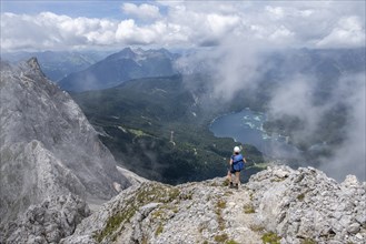 Mountaineer at Waxenstein with fog, Eibsee lake, Wetterstein Mountains, Garmisch-Patenkirchen,