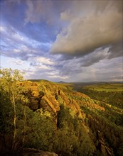 Schrammstein view in the Elbe Sandstone Mountains Looking up the Elbe. Leisurely hikers clamber