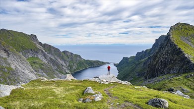 Mountaineers on the hiking trail to Munkebu hut, view of Djupfjorden fjord, Moskenesoya, Lofoten,