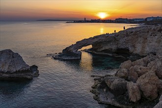 The natural rock bridge Love Bridge in the sunset, Agia Napa, Cyprus, Europe