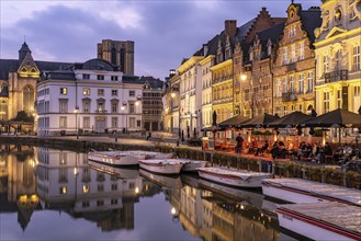 Gastronomy and historic houses on the Korenlei quay on the river Leie at dusk, Ghent, Belgium,