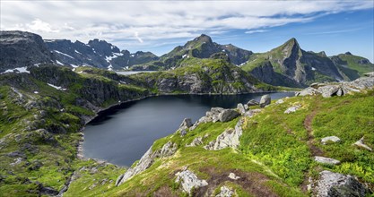 Mountain landscape with rocky peaks and lakes, with mountain Hermannsdalstinden and lakes