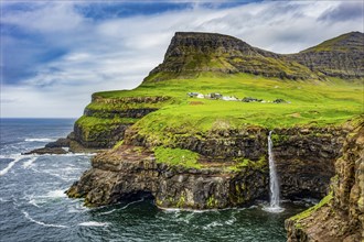 Gasadalur waterfall into the ocean, Vagar, Faroe islands, Denmark, Europe