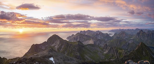 View over mountain top and sea, dramatic sunset, from the top of Hermannsdalstinden, Moskenesöy,