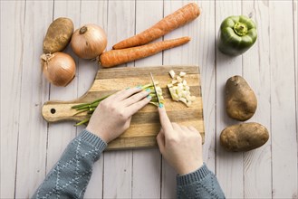 An overhead shot of cutting up assorted vegetables on a cutting board