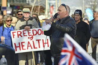 CHRISTCHURCH, NEW ZEALAND, JULY 24, 2021, A man speaks at a protest rally at the Bridge of