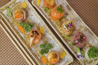 Platter decorated with different flavors of elegant sushi. Selective focus