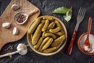 Pickled cucumbers with salt, pepper, garlic, and bay leaf. Fermented food. Homemade canned gherkins