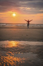 Tourist on the beach at sunset, Zandvoort, Netherlands