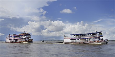 Traditional wooden boats navigating on the Rio Negro, Manaus, Amazonia State, Brazil, South America