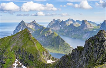 Mountain landscape with steep rocky peaks fjords and sea, view from the top of Munken to