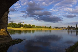 View through the arches of the Marienbrücke onto the Elbe meadows in Dresden's Old Town with