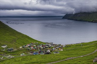 Little village Funnigur in a huge fjord, Estuyroy, Faroe islands, Denmark, Europe