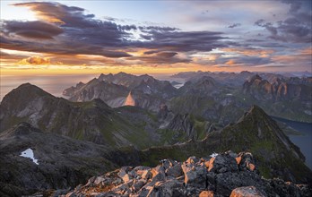 View over mountain top and sea, dramatic sunset, from the top of Hermannsdalstinden, Moskenesöy,