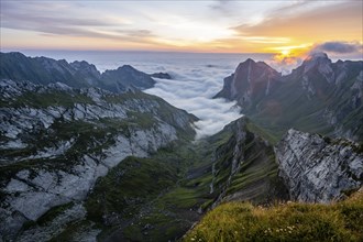 View over Säntis mountains into the valley of Meglisalp at sunrise, high fog in the valley, Säntis,