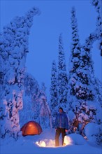 Man with bivouac in the snow, Lapland, Sweden, Europe