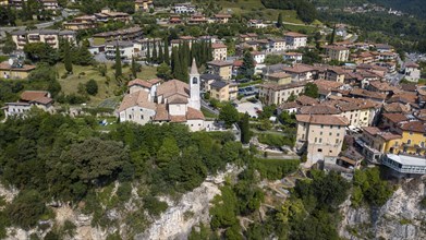 View of village resort Tremosine in the middle Catholic church Chiesa di Pieve on steep rock face