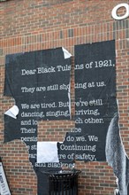 Tulsa, Oklahoma, A defaced poster in the Greenwood District, known as the Black Wall Street. The