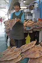 Korean market woman, 65, with dried grouper, Yeosu Fish Market, Yeosu, Jeollanam-do Province, South